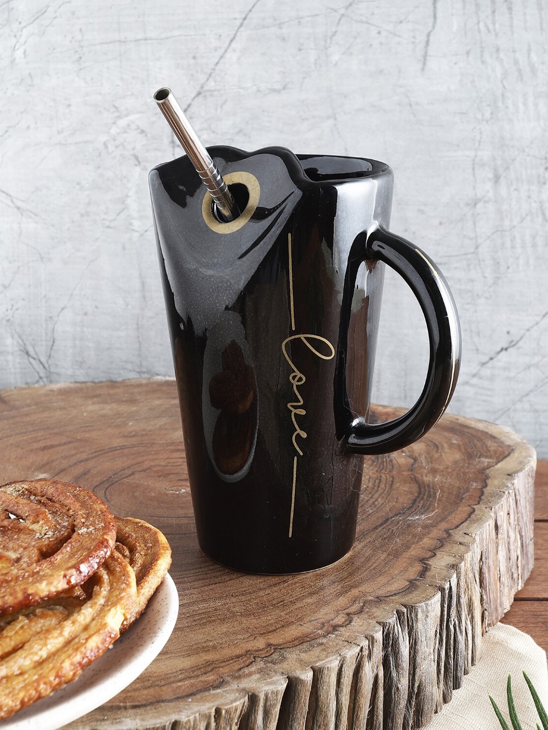 

The Decor Mart Black & Gold-Toned Printed Ceramic Glossy Mug With Steel Strow