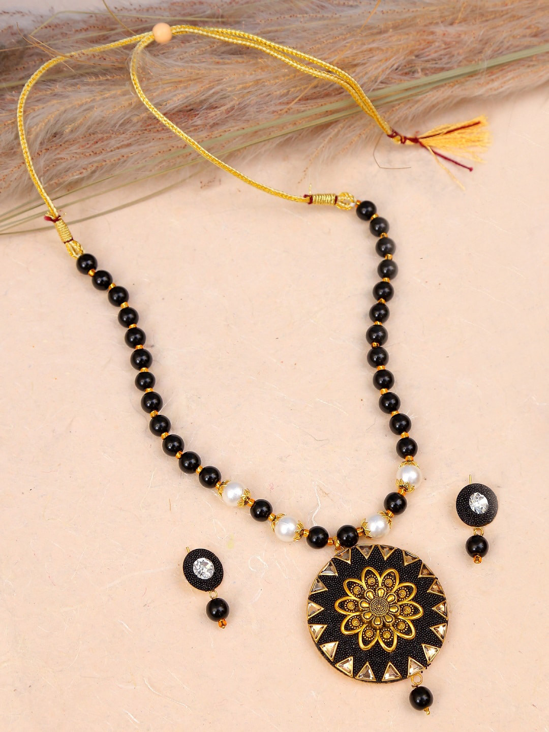 

Crunchy Fashion Enamelled Gold-Plated Black & White Pearls Beaded & Stone Studded Jewellery Set