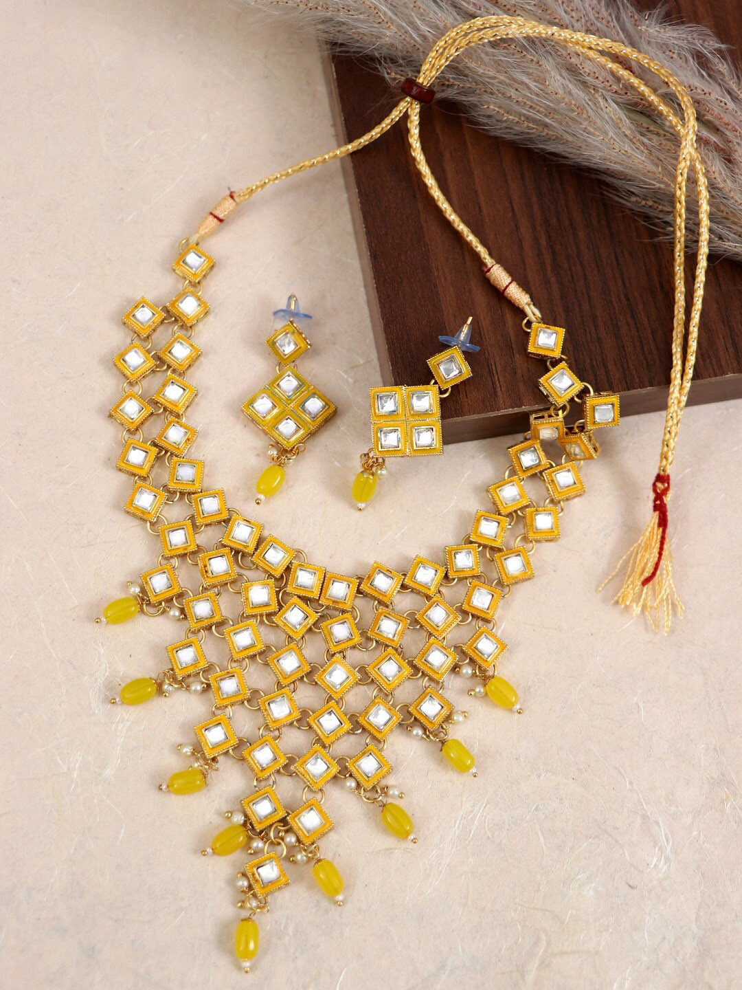 

Crunchy Fashion Enamelled Gold-Plated Yellow & White Kundan Studded & Pearls Beaded Jewellery Set