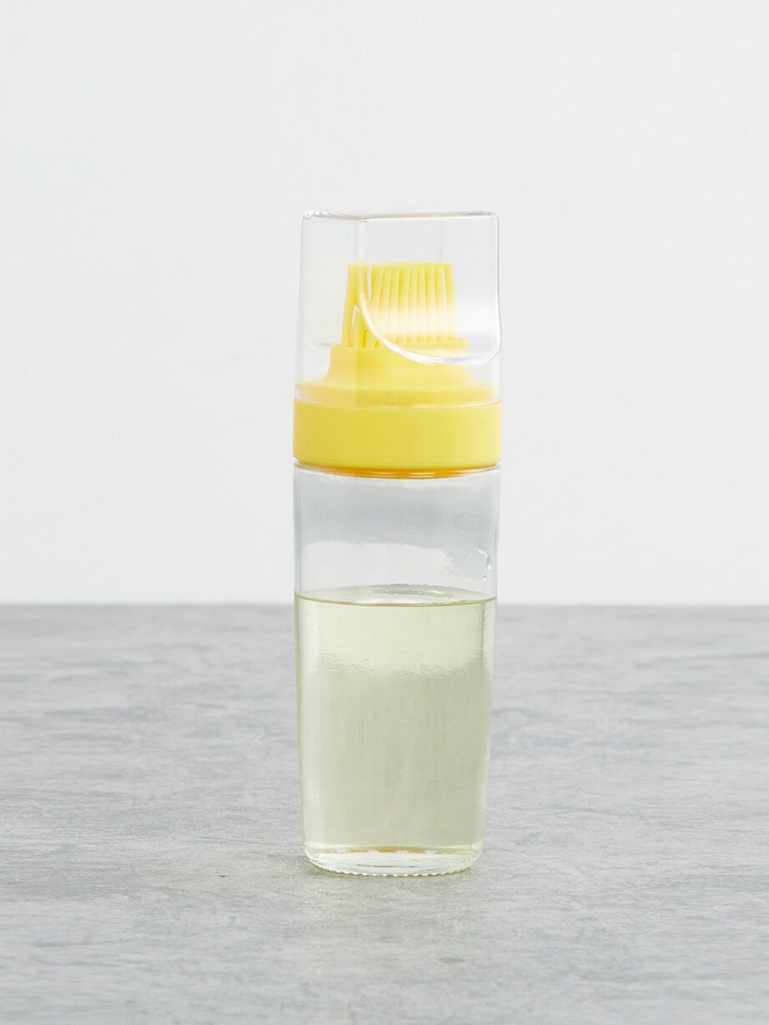 

Home Centre Transparent & Yellow Glass Oil Bottle With Brush