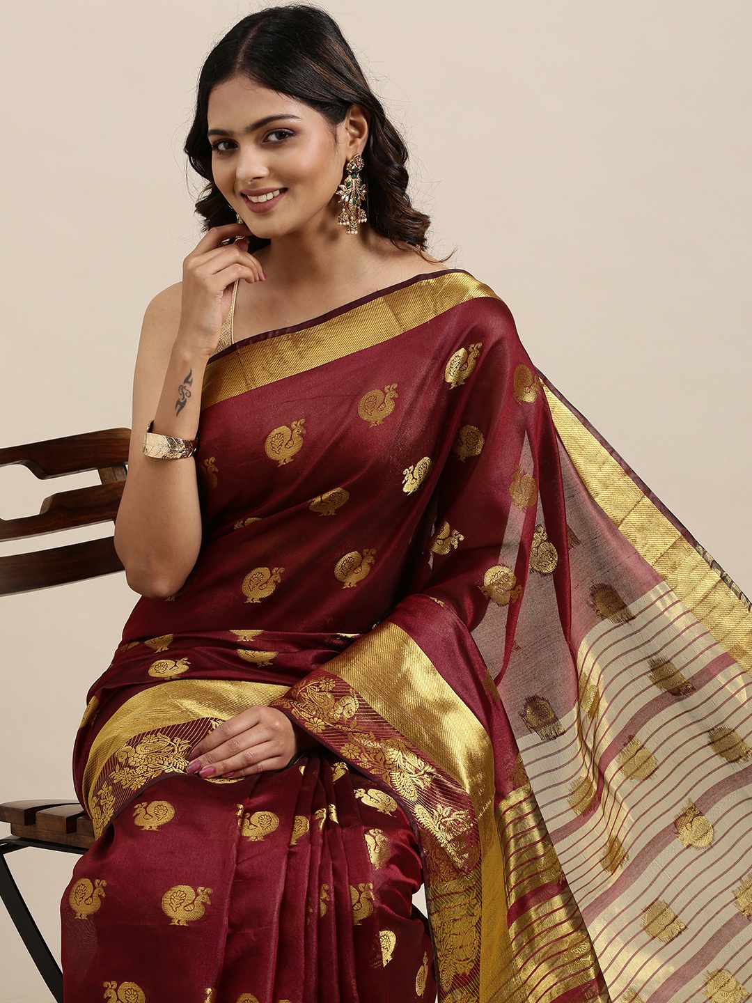 

Mitera Women Maroon & Golden Ethnic Motifs Printed Saree