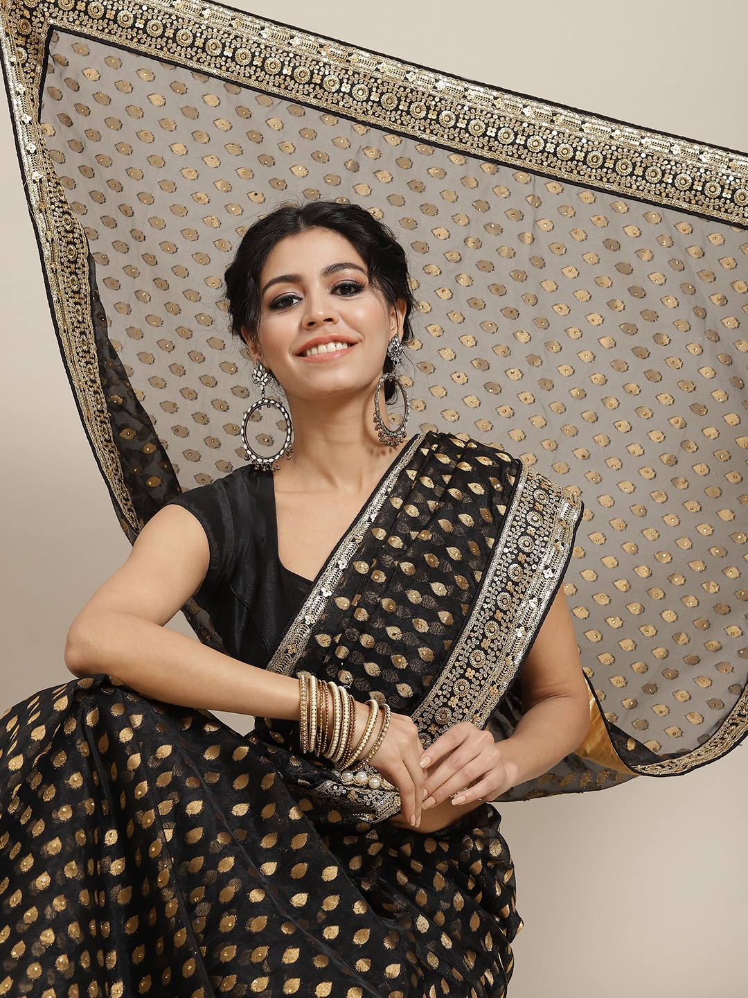 

Mitera Black & Golden Ethnic Motifs Woven Design Organza Saree