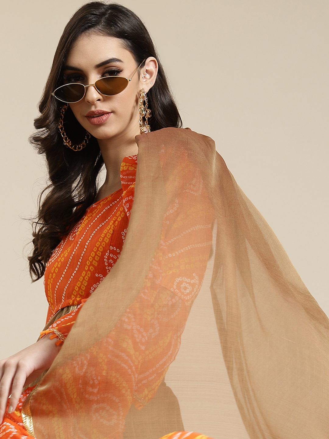 

Mitera Beige & Orange Checked & Leheriya Printed Saree