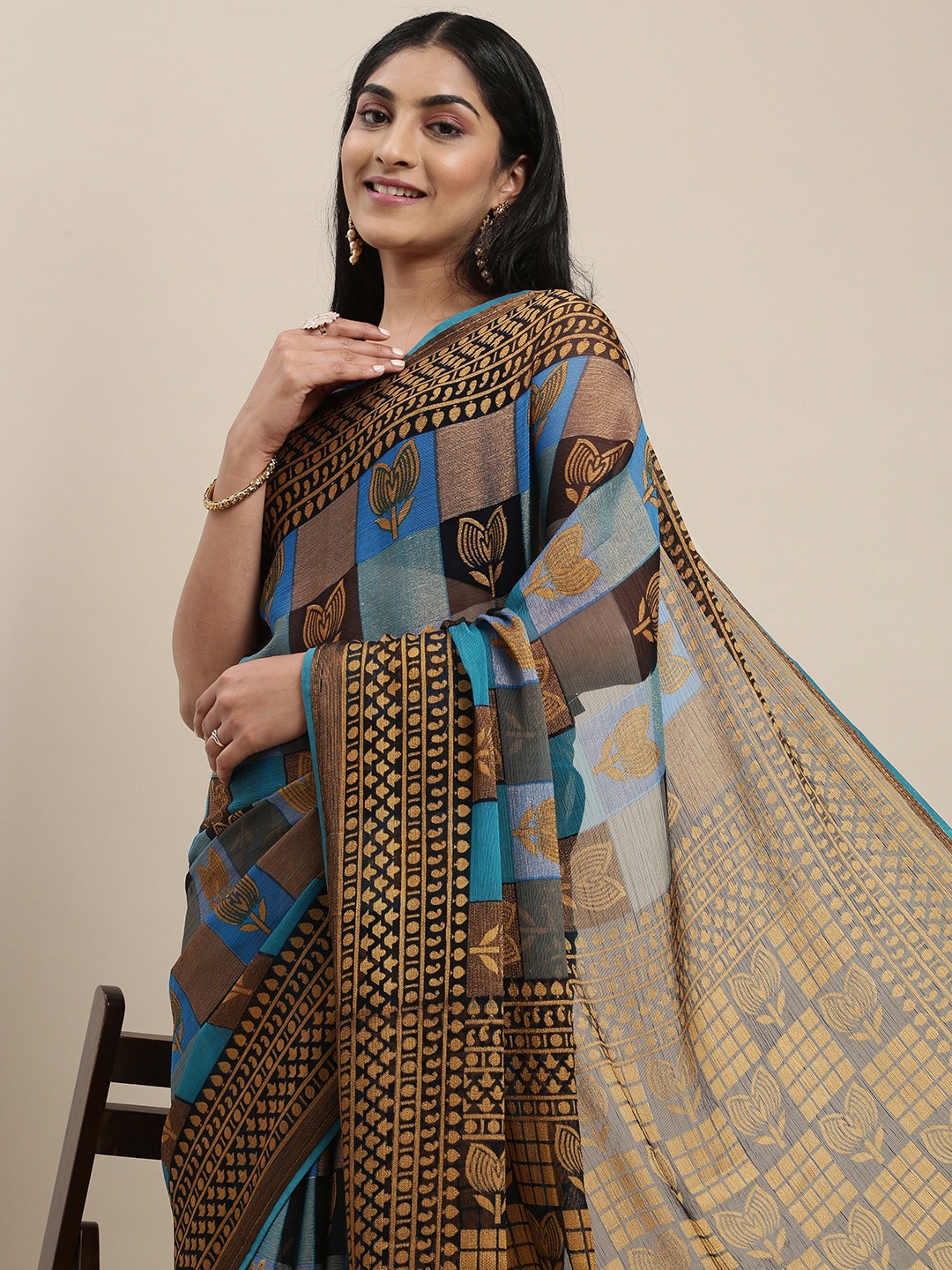 

Triveni Blue & Khaki Floral Brasso Saree