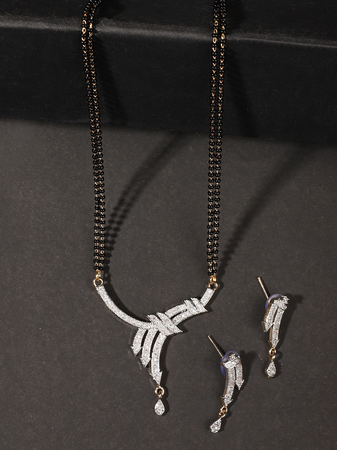 

ANIKAS CREATION Gold-Plated White & Black Stone Studded & Beaded Layered Jewellery Set