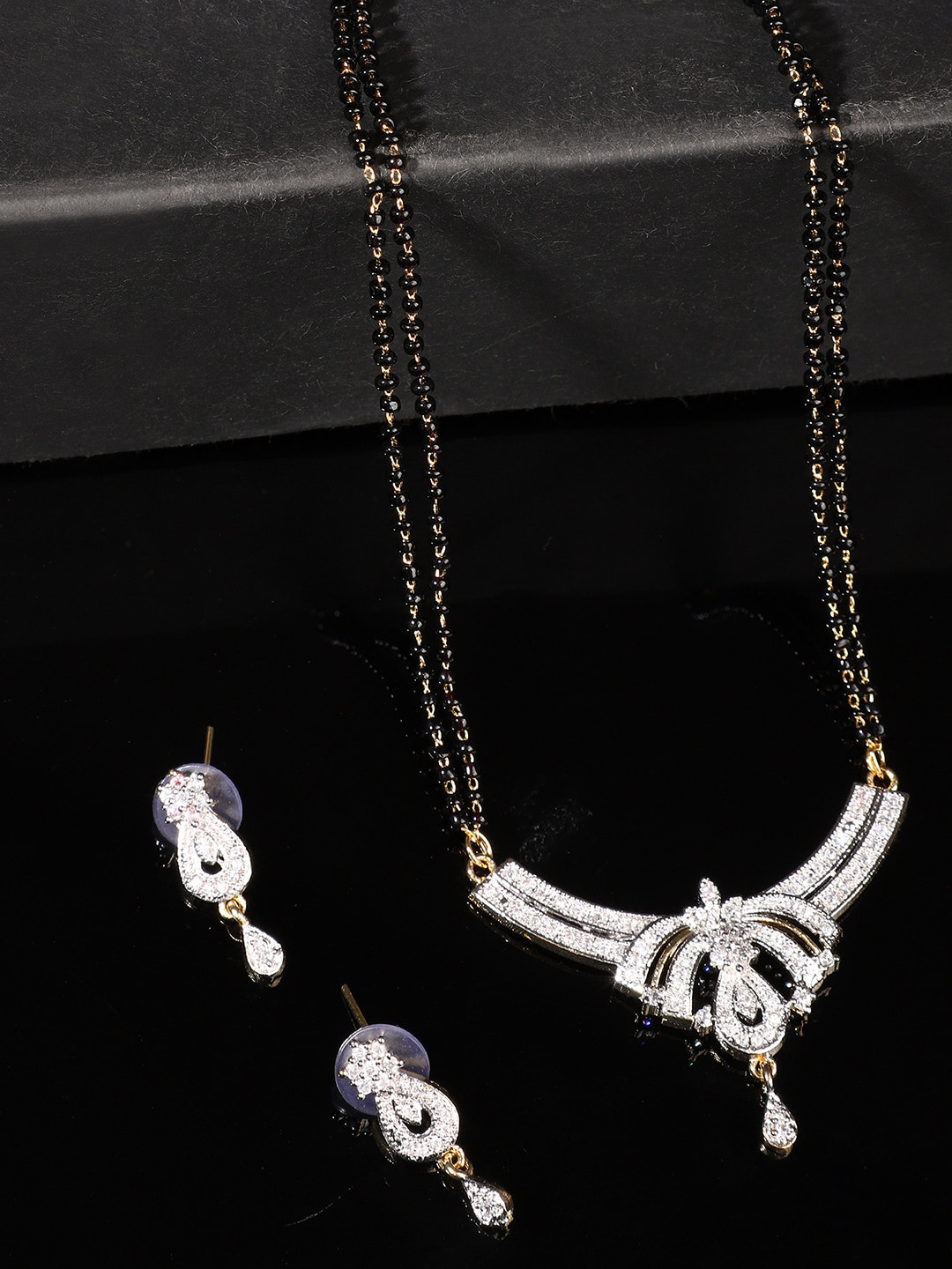 

ANIKAS CREATION Gold-Plated Black & White Stone-Studded & Beaded Mangalsutra With Earrings