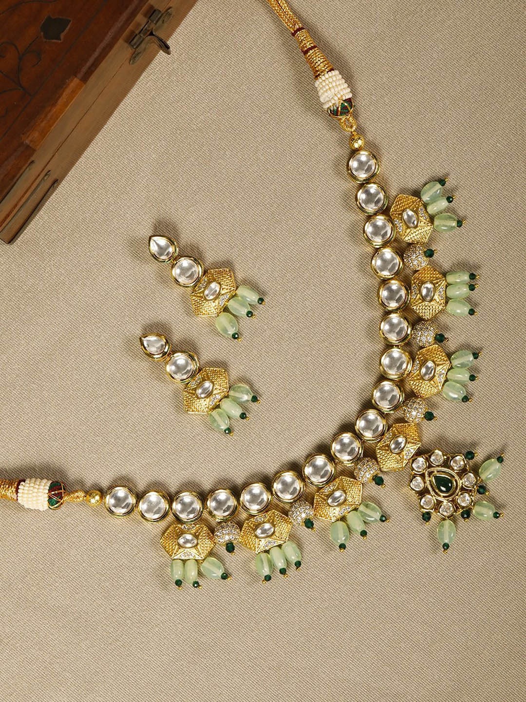 

Priyaasi Woman Gold-Plated White & Green Stone-Studded & Beaded Jewellery Set