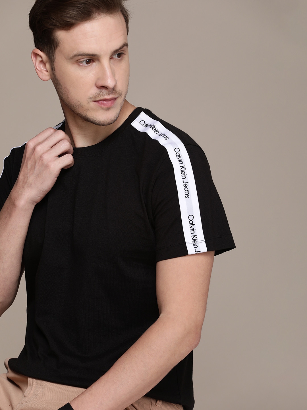 

Calvin Klein Jeans Men Black Solid Pure Cotton T-shirt with Brand Logo Shoulder Taping