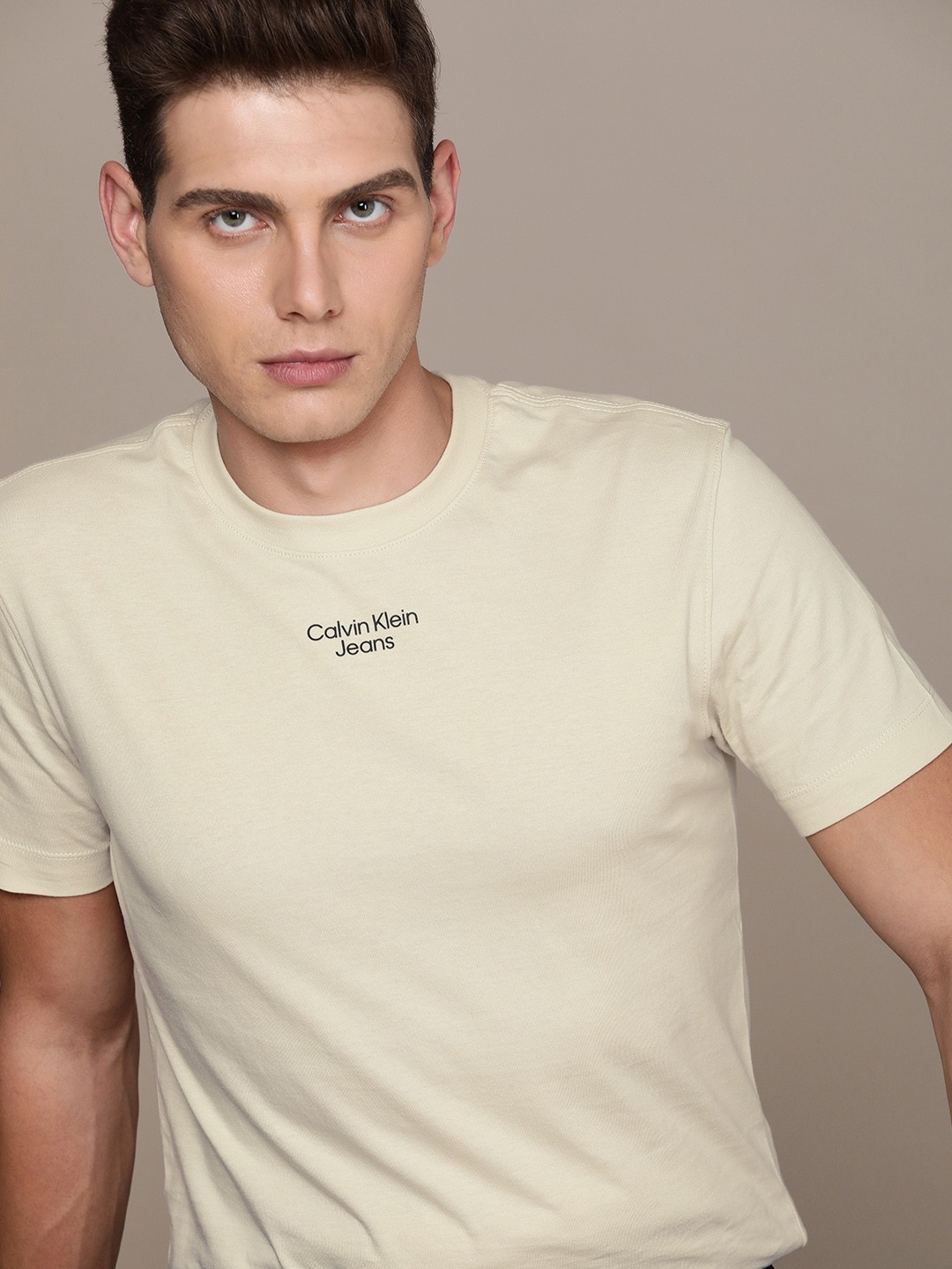 

Calvin Klein Jeans Men Off White Solid Organic Cotton Brand Logo Applique Slim Fit T-shirt