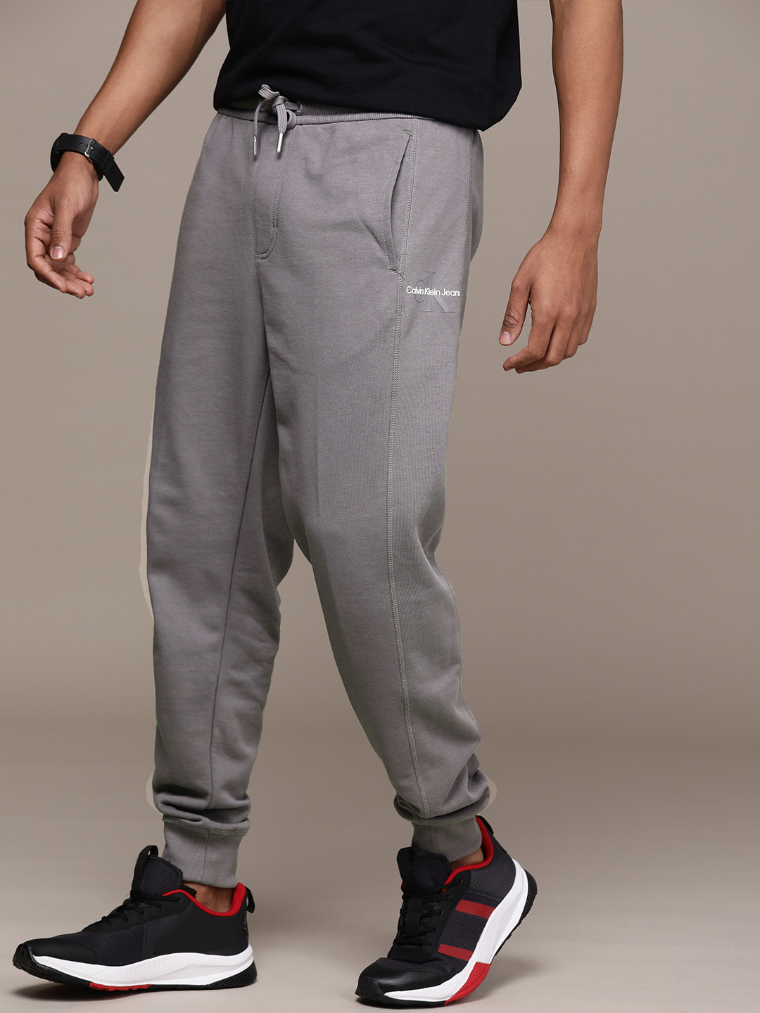 

Calvin Klein Jeans Men Grey Solid Mid Rise Pure Cotton Regular Joggers