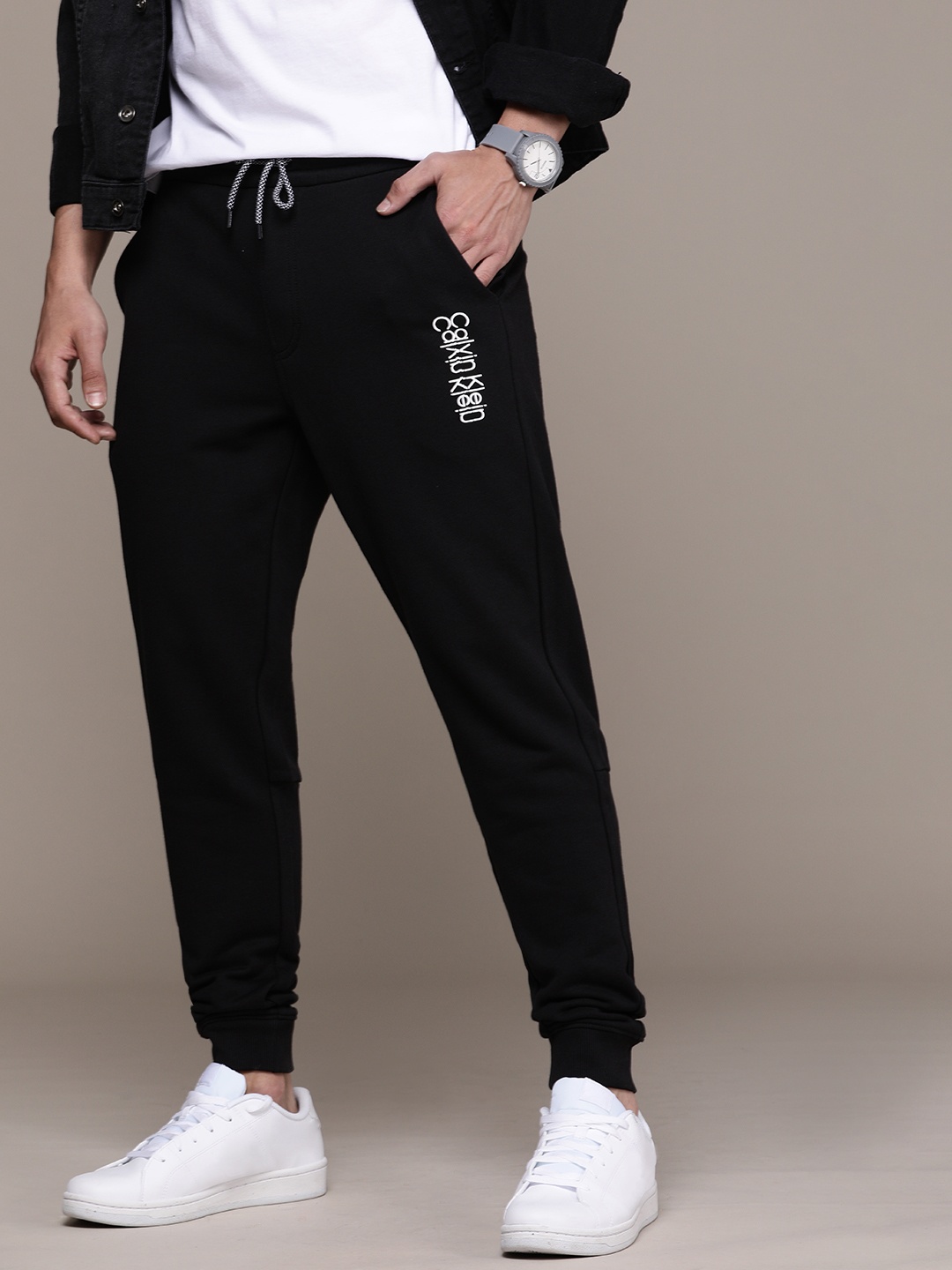 

Calvin Klein Jeans Men Black Brand Logo Printed Mid Rise Casual Joggers Track Pants