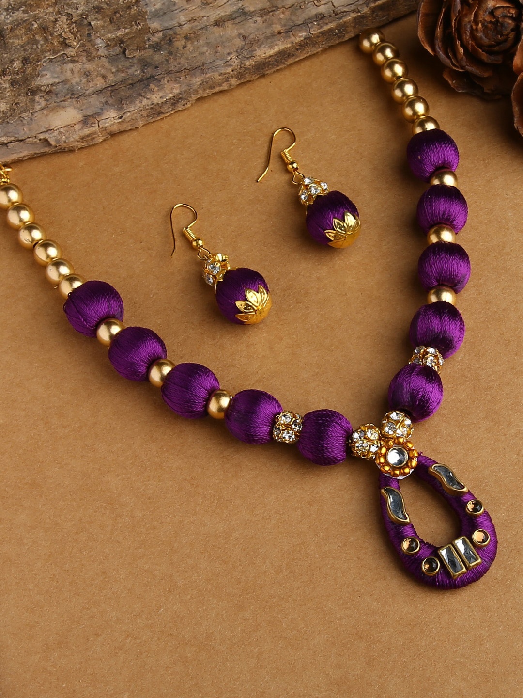 

AKSHARA Women Purple Stone-Studded Wooden Balls Silk Thread Jewelry Set, Gold