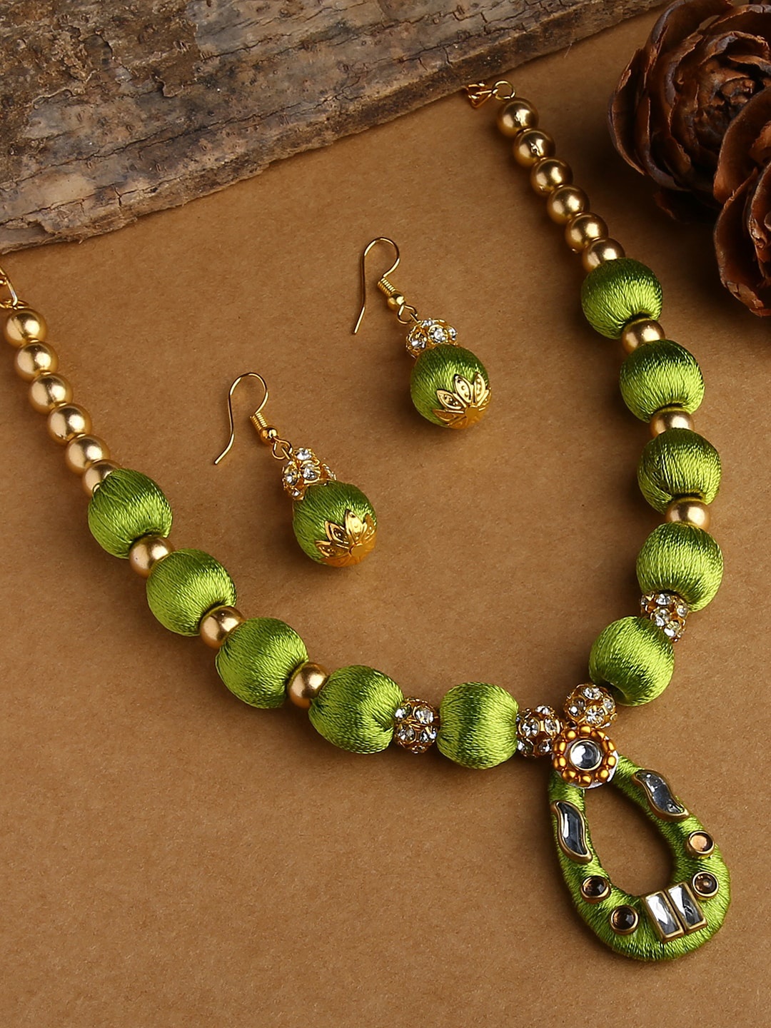 

AKSHARA Gold-Plated White & Green Stone-Studded Wooden Balls Silk Thread Jewellery Set