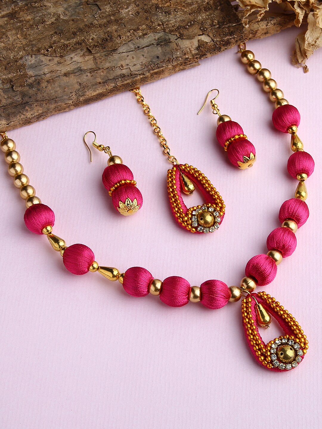 

AKSHARA Gold-Plated White Stone-Studded Pink Wooden Balls Silk Thread Jewellery Set