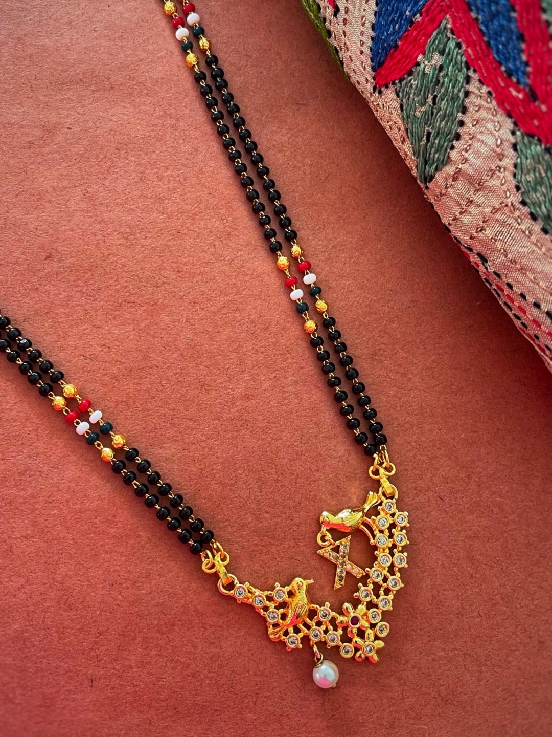 

Digital Dress Room Gold-Plated Black & White Beaded & Stone-Studded X-Alphabet Mangalsutra