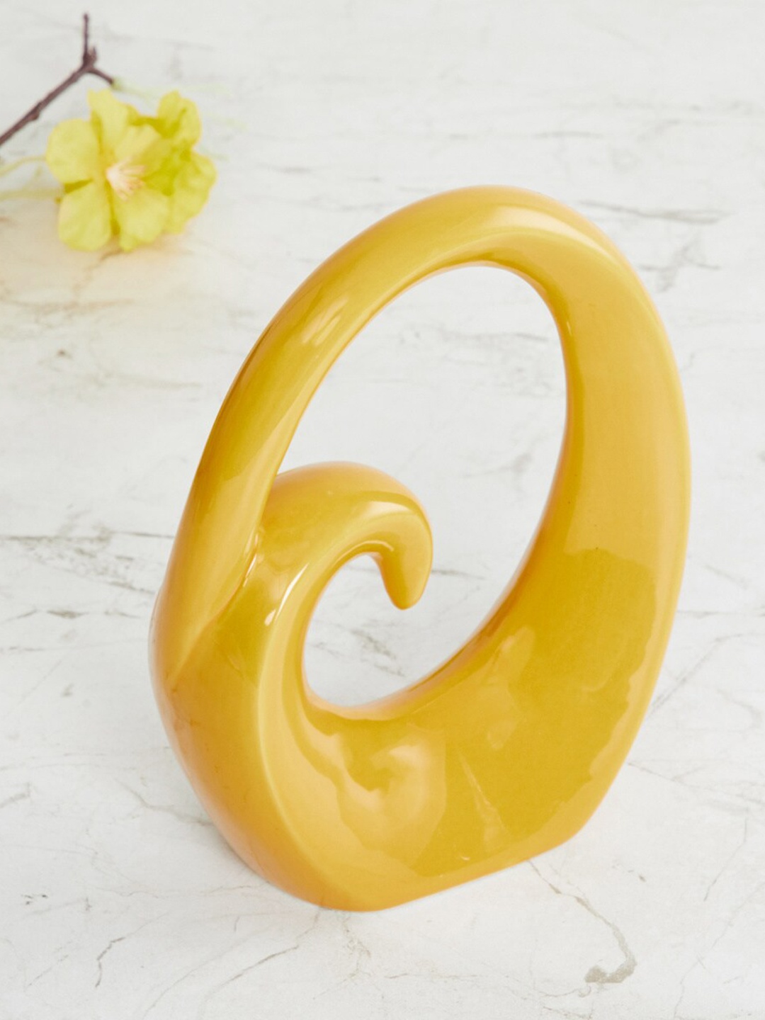 

Home Centre Yellow Solid Ceramic Showpiece