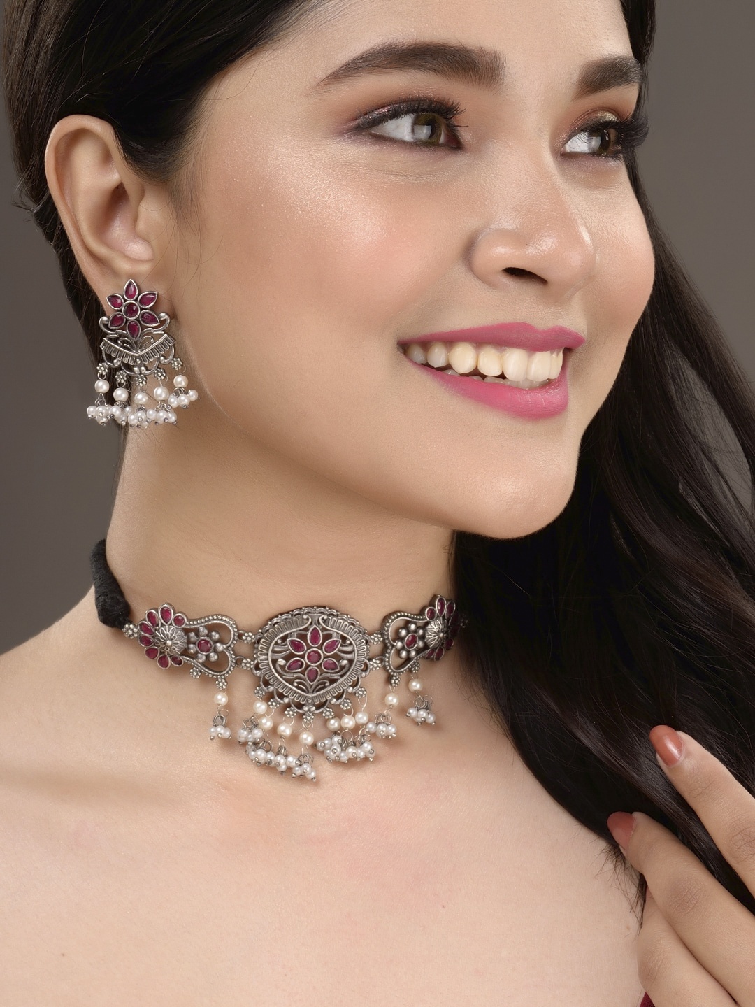 

Saraf RS Jewellery Silver-Toned & Red Oxidised Stone-Studded Tribal Jewellery Set