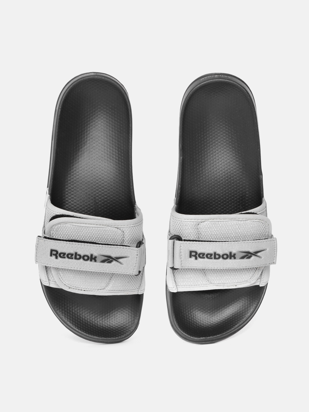 

Reebok Men Grey & Black Woven Design Sliders with Brand Logo Print Detail