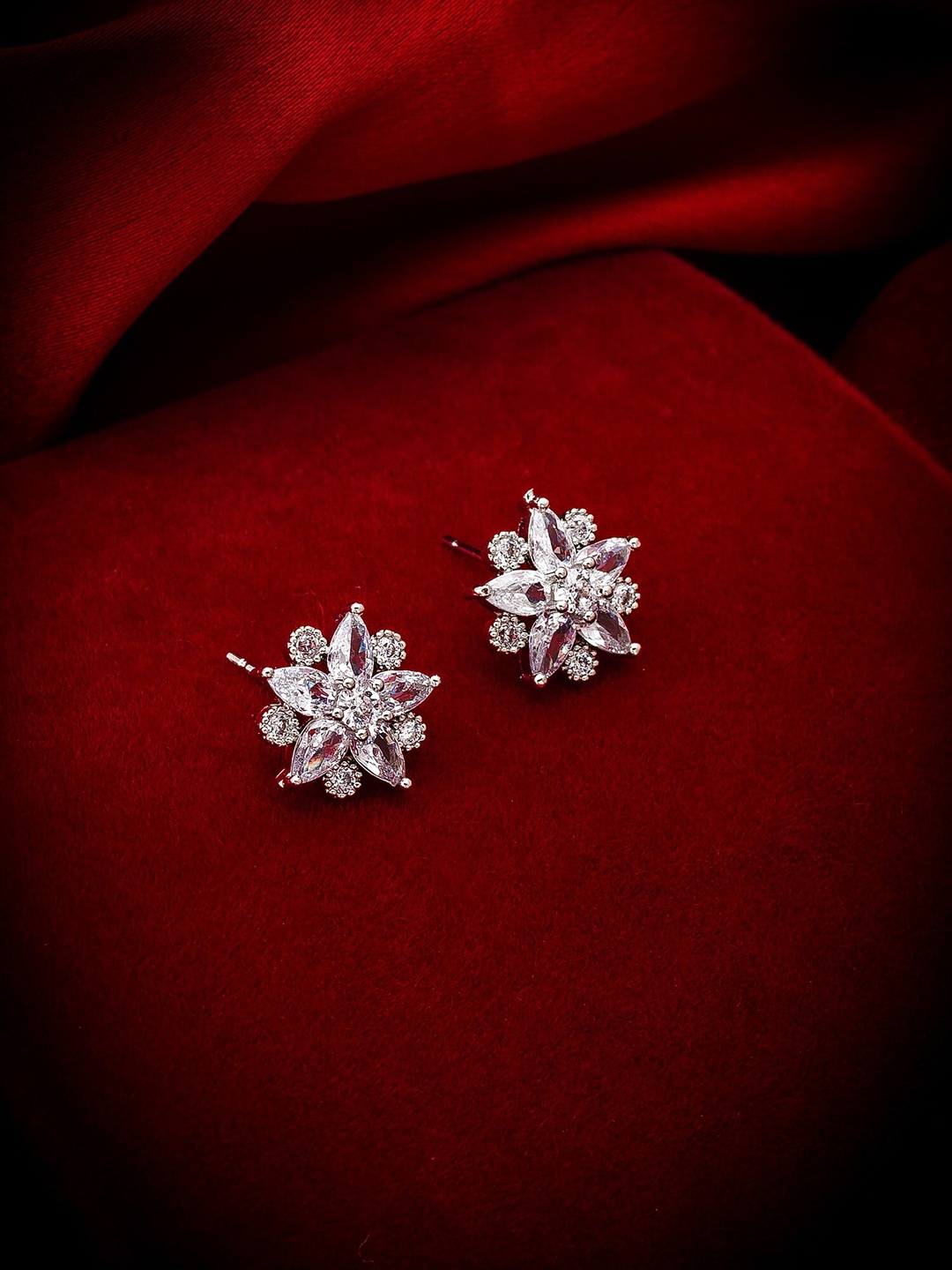 

aadita Silver-Toned Floral Studs Earrings