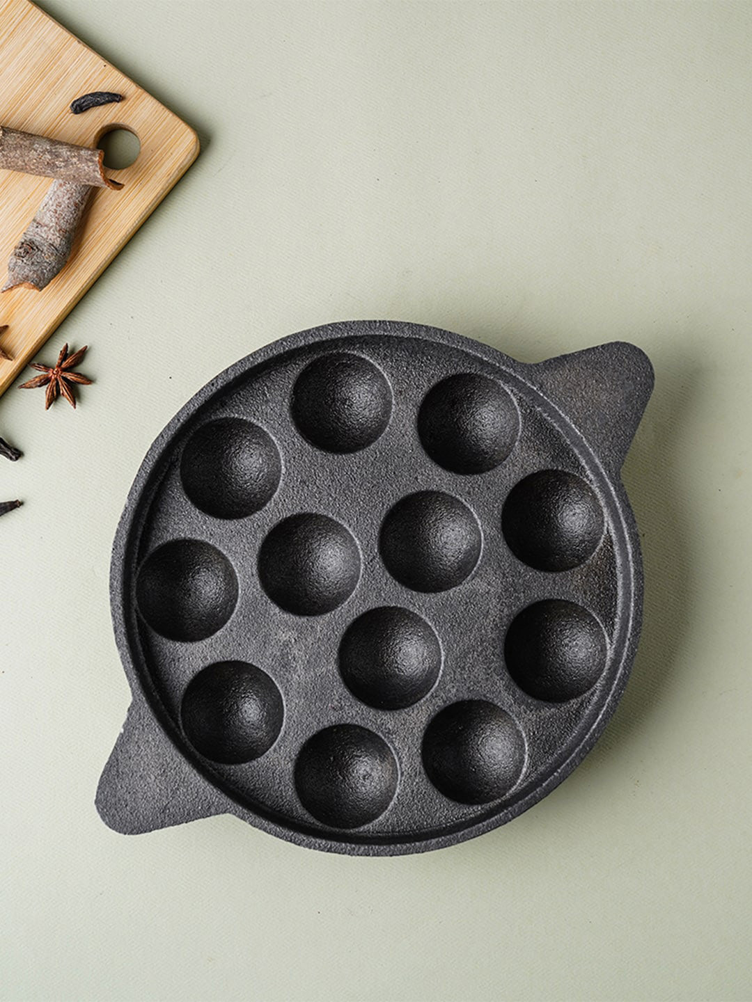 

The Indus Valley Black Pre Seasoned Super Smooth Cast Iron Cast Iron 12 Pit Paniyaram Pan
