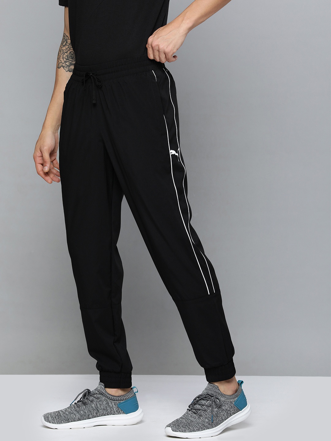 

Puma Men Black Solid DryCell Regular Fit Mid Rise WovenTraining Sustainable Sustainable Joggers With Side Stripe