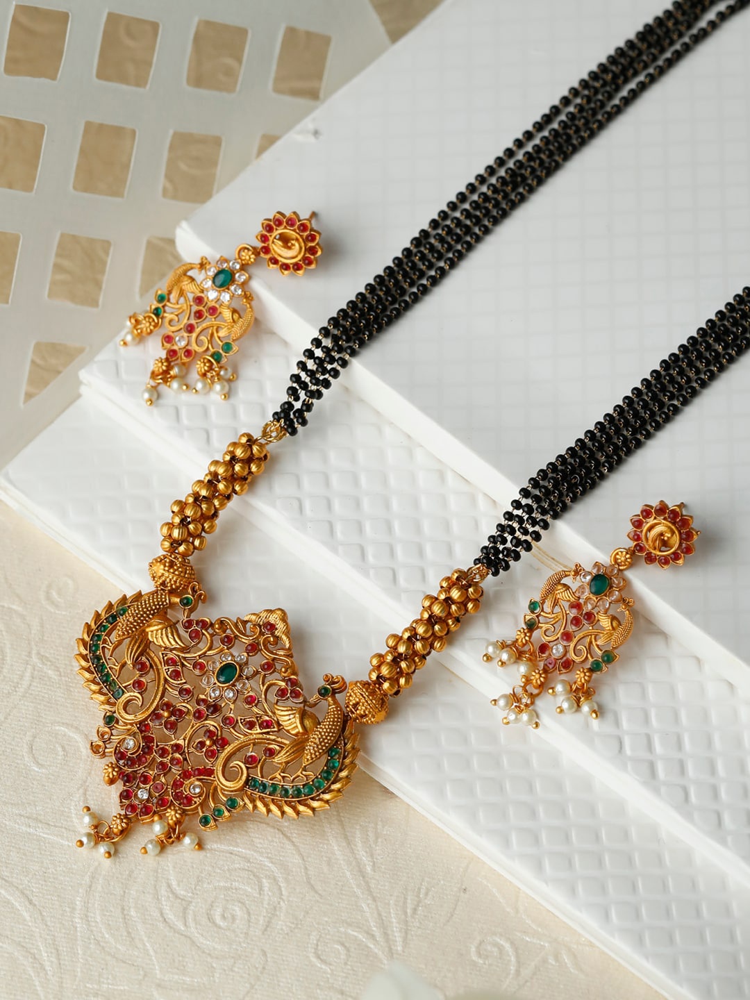 

Priyaasi Gold-Plated & Black Stone Studded & Beaded Jewellery Set