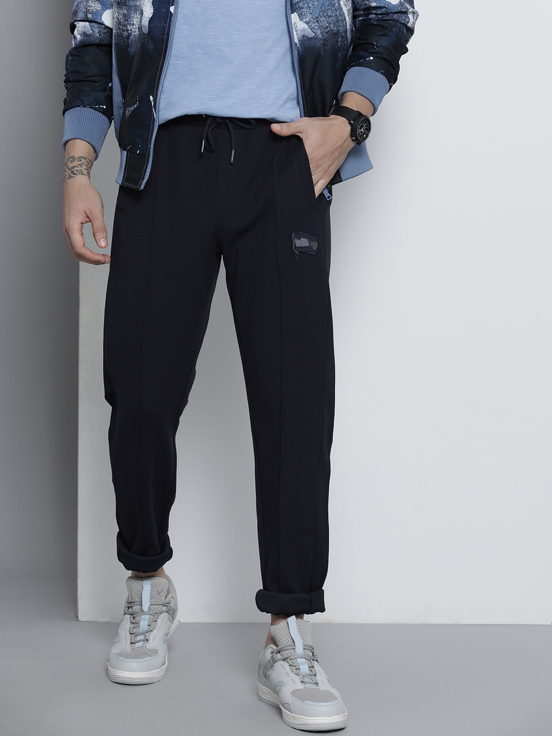 

Tommy Hilfiger Men Navy Blue Solid Mid-Rise Regular Track Pants