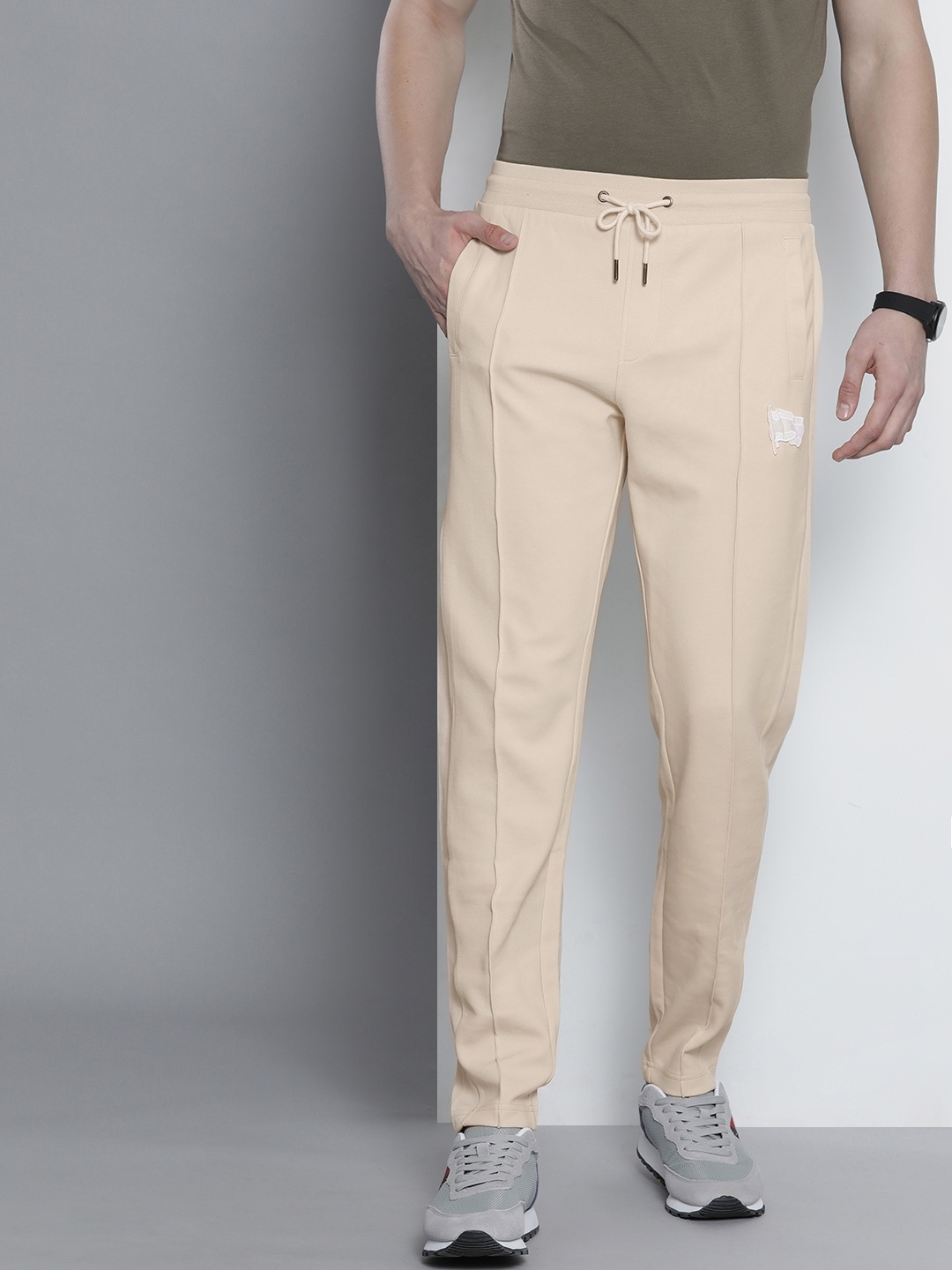 

Tommy Hilfiger Men Beige Solid Casual Track Pants