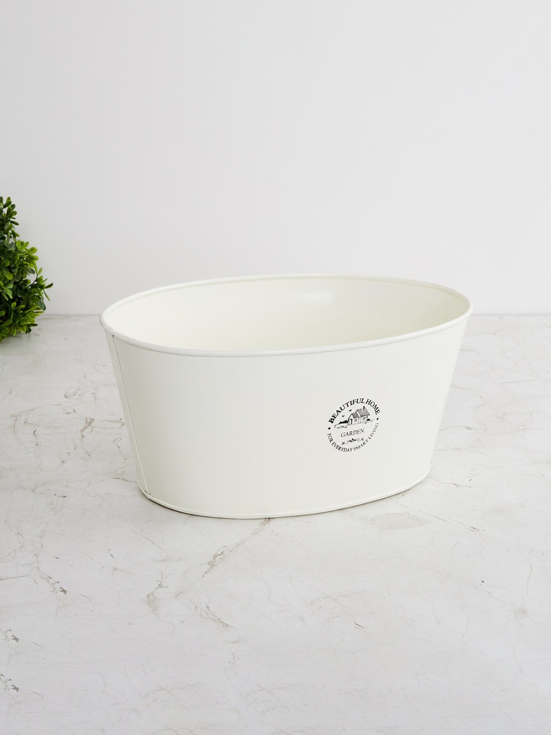 

Home Centre Off White Printed Oval Metal Planter
