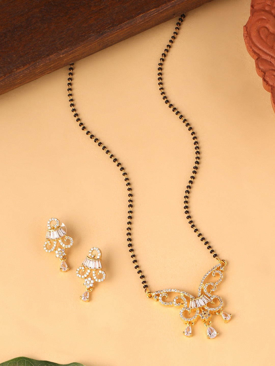 

VIRAASI Gold-Plated White Stone-Studded & Black Beaded Mangalsutra With Earrings Set