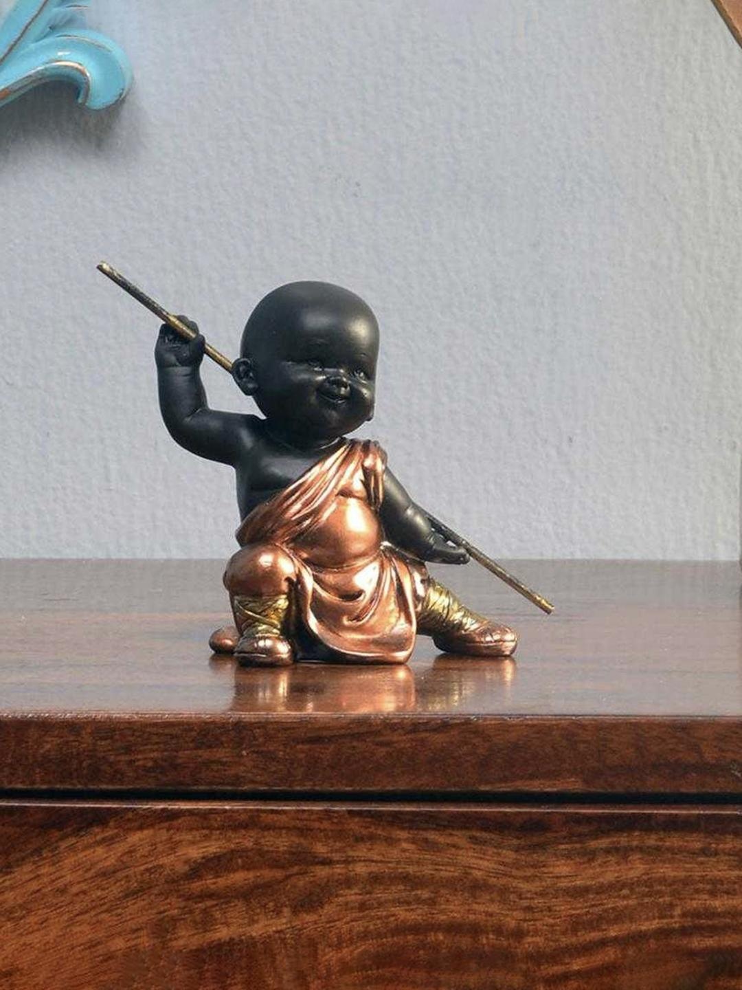 

Athome by Nilkamal Brown Baby Monk Holding Stick Showpiece