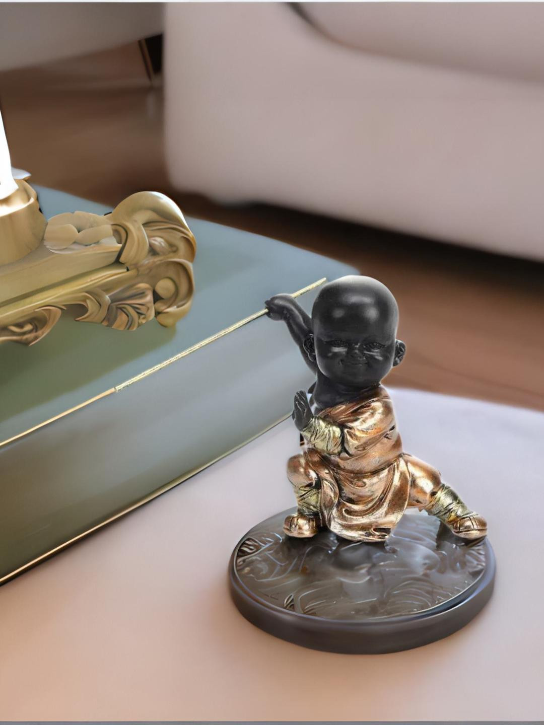 

Athome by Nilkamal Copper-Toned & Black Baby Monk Holding Stick Showpiece