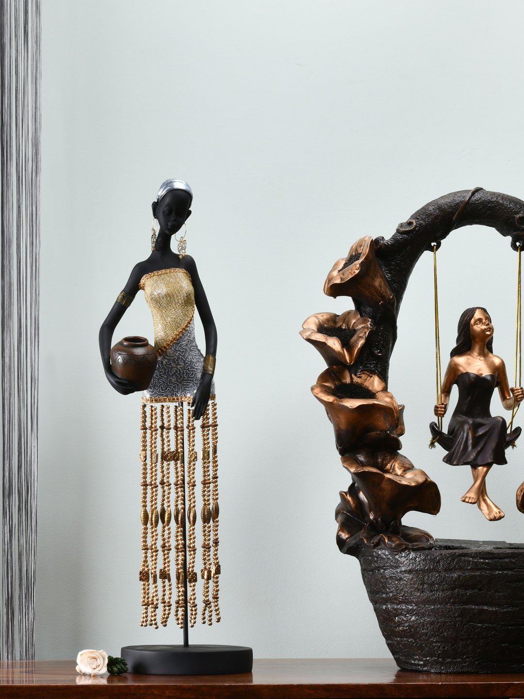 

Athome by Nilkamal Black & Gold Colored Tribal Lady Holding Pot Showpiece
