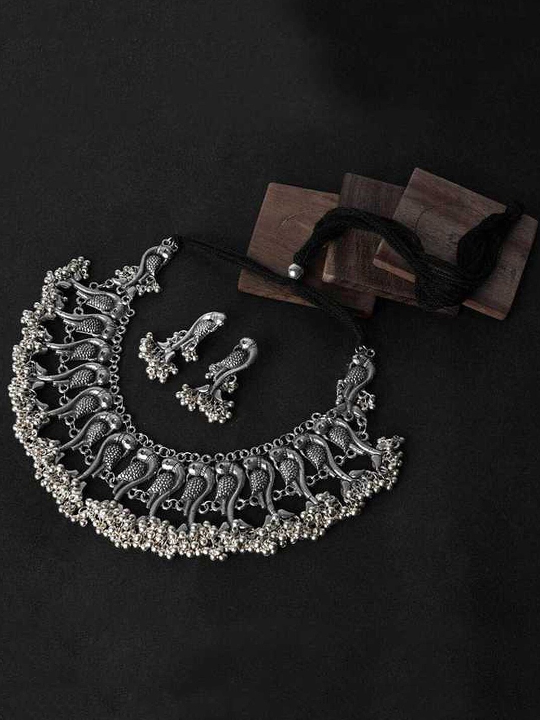 

Vembley Oxidised Silver-Plated Beaded Ghungroo Peacock Carved Antique Jewellery Set