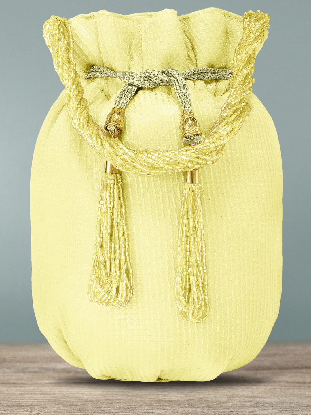 

Peora Women Yellow Tasselled Detail Potli Clutch