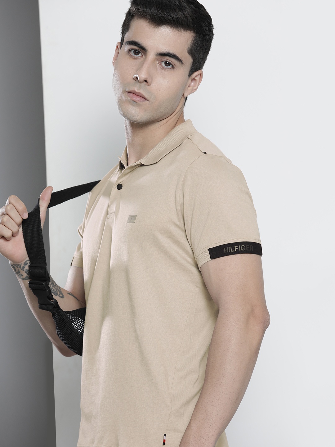 

Tommy Hilfiger Men Beige Solid Polo Collar Regular Sleeves Applique Slim Fit T-shirt