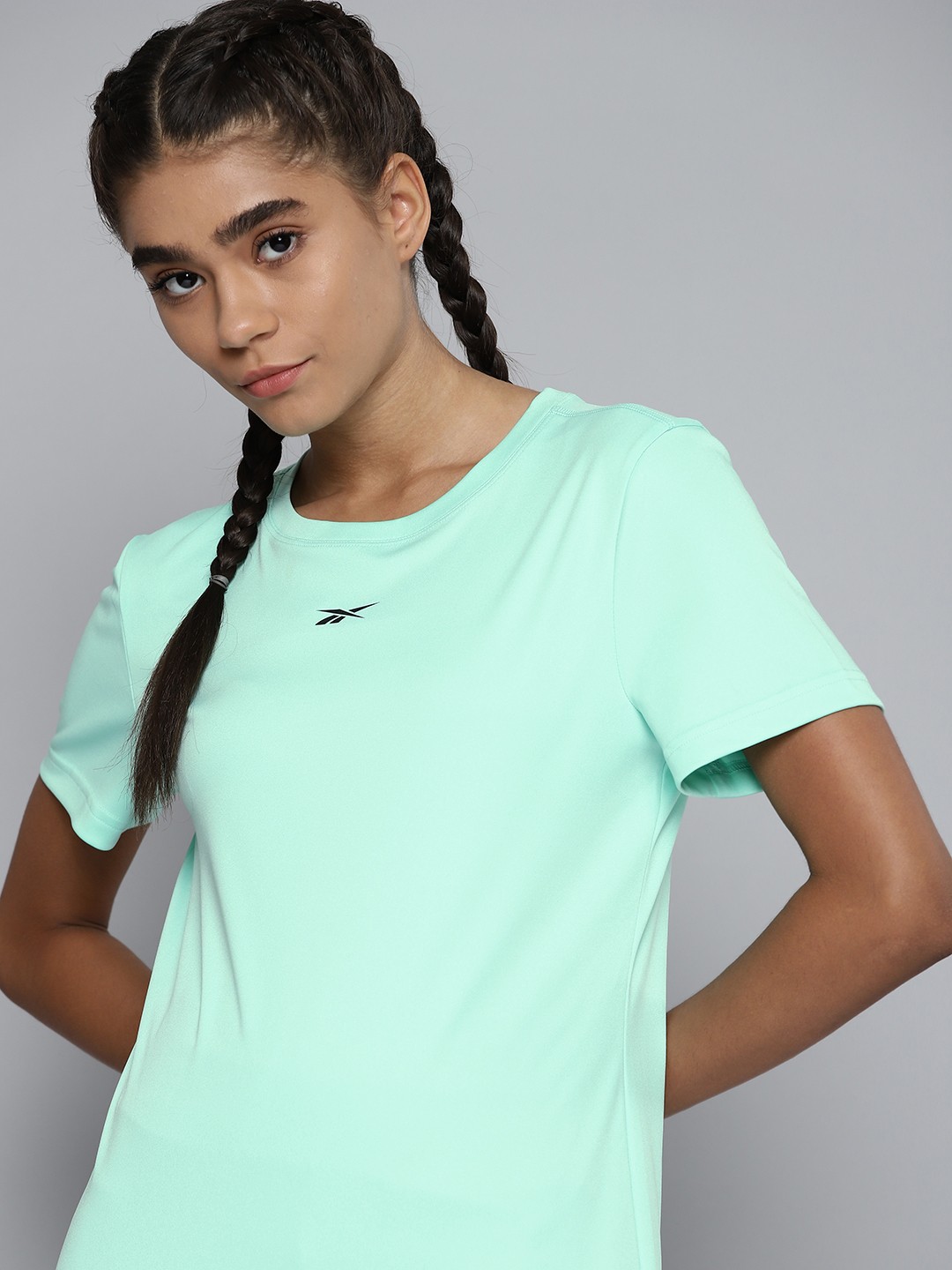 

Reebok Women Sea Green Solid Training or Gym T-shirt