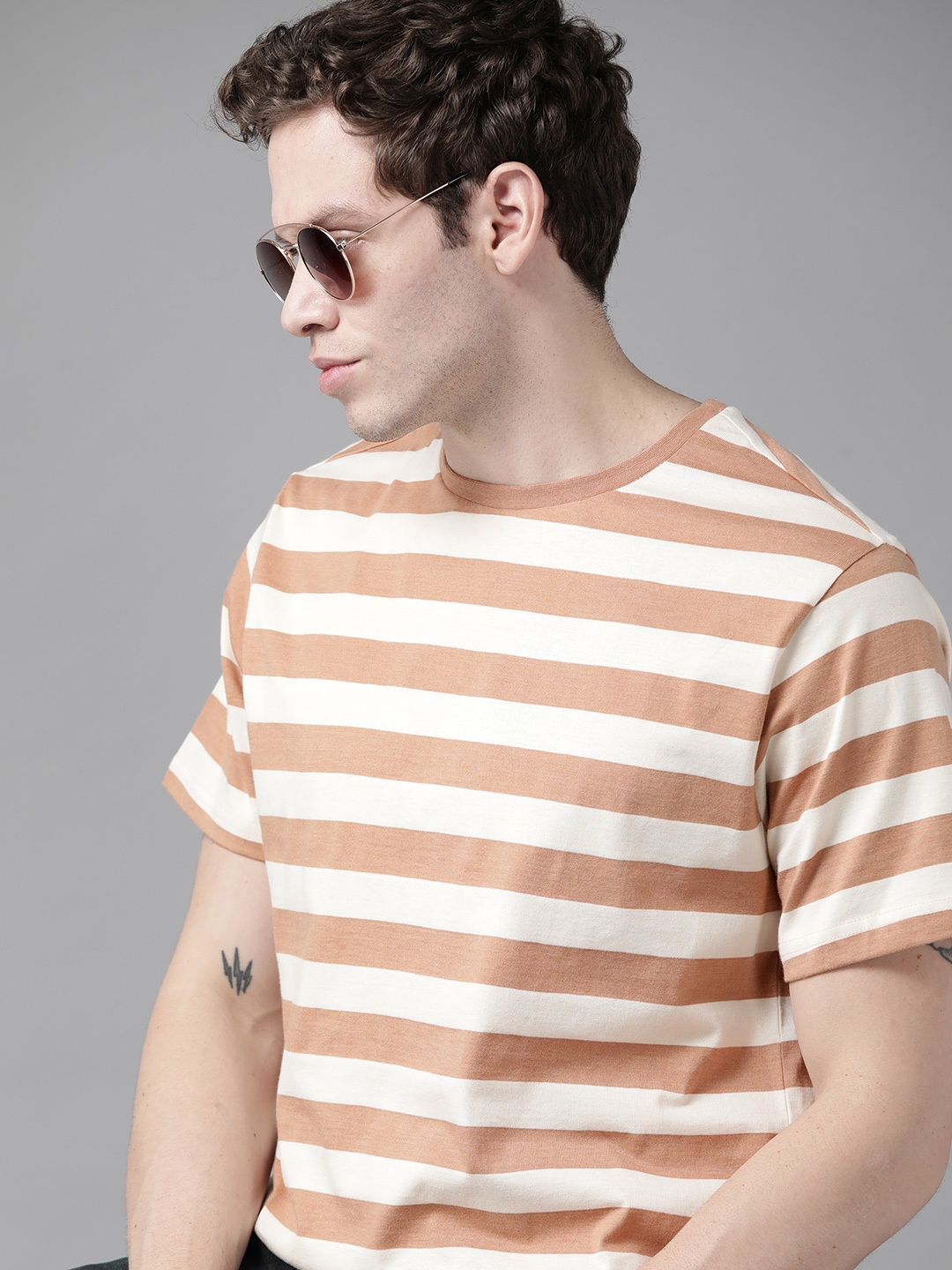 

Roadster Men Beige Pure Cotton Striped T-shirt