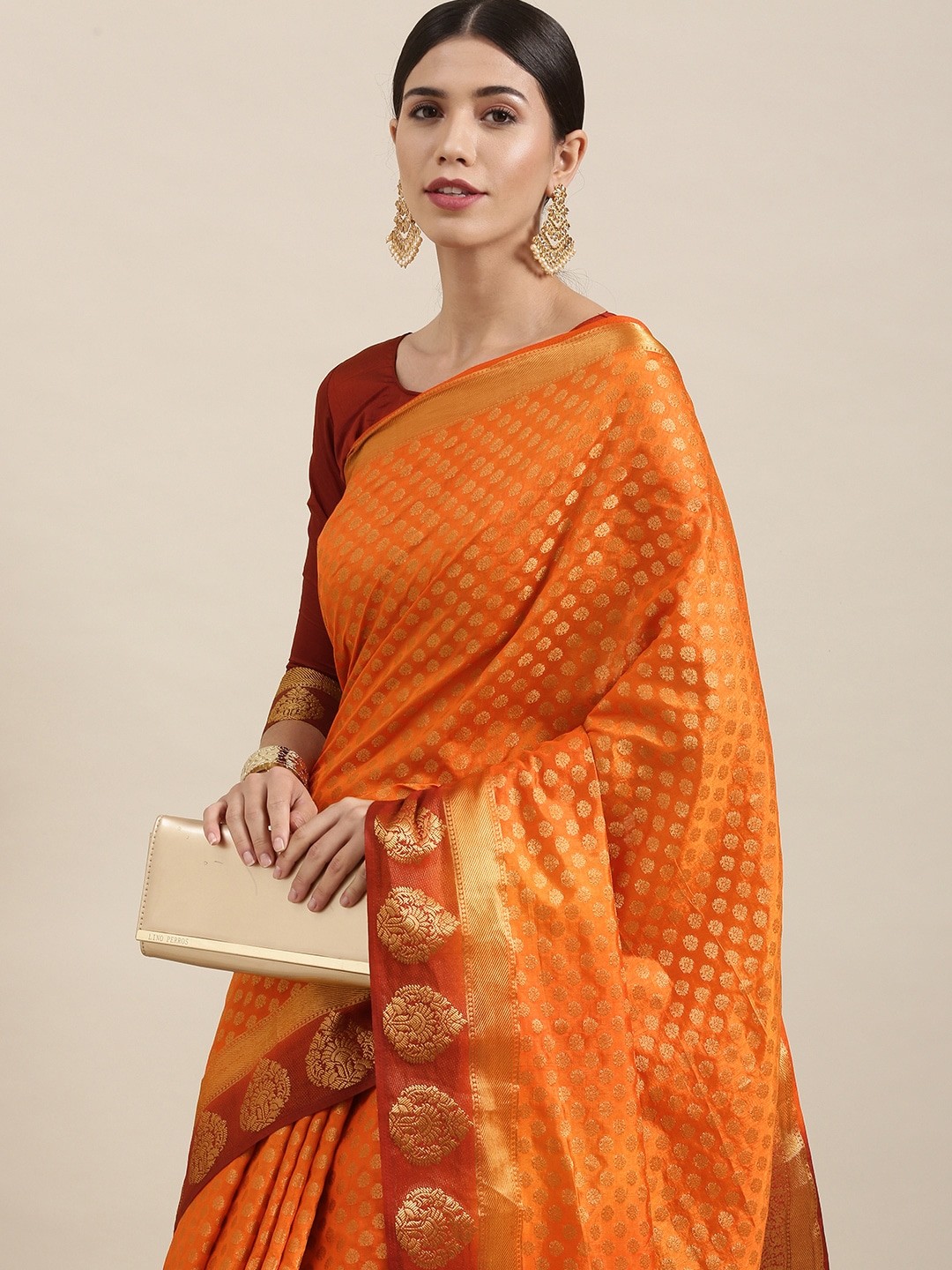 

Mitera Orange & Gold Ethnic Motifs Zari Silk Blend Saree