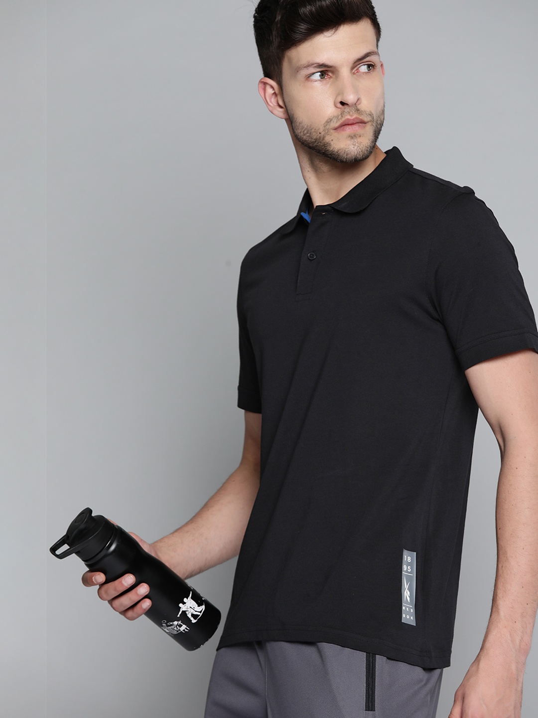 

Reebok Men Black Solid Polo Collar Pure Cotton Training T-shirt