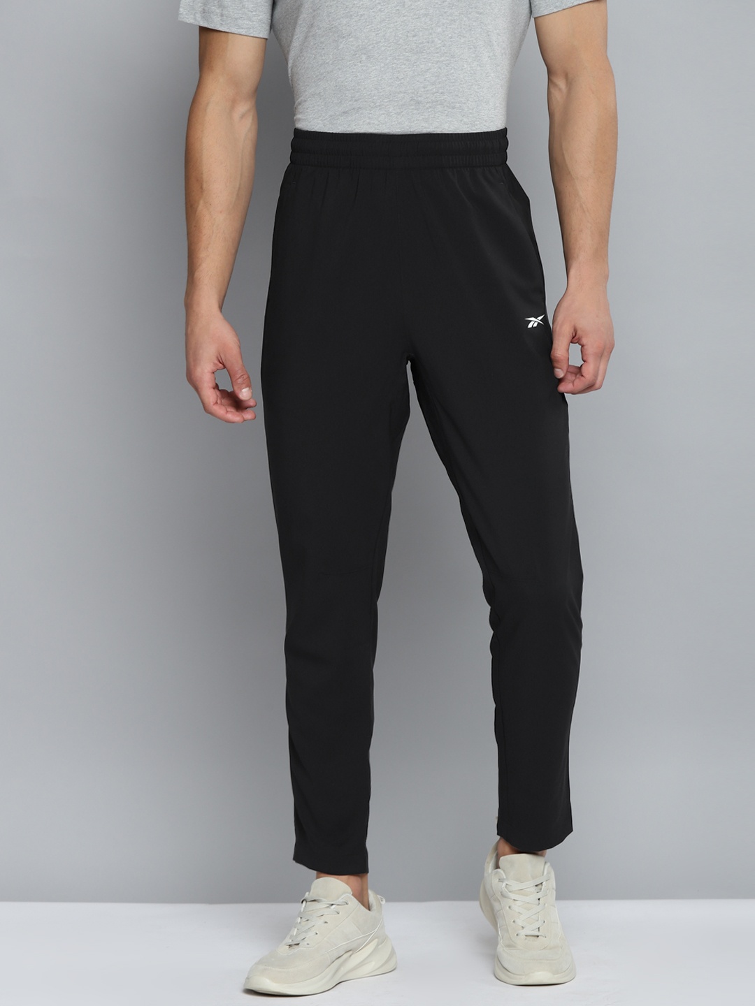 

Reebok Men Black Solid WOR Woven Trackster Training Track Pants