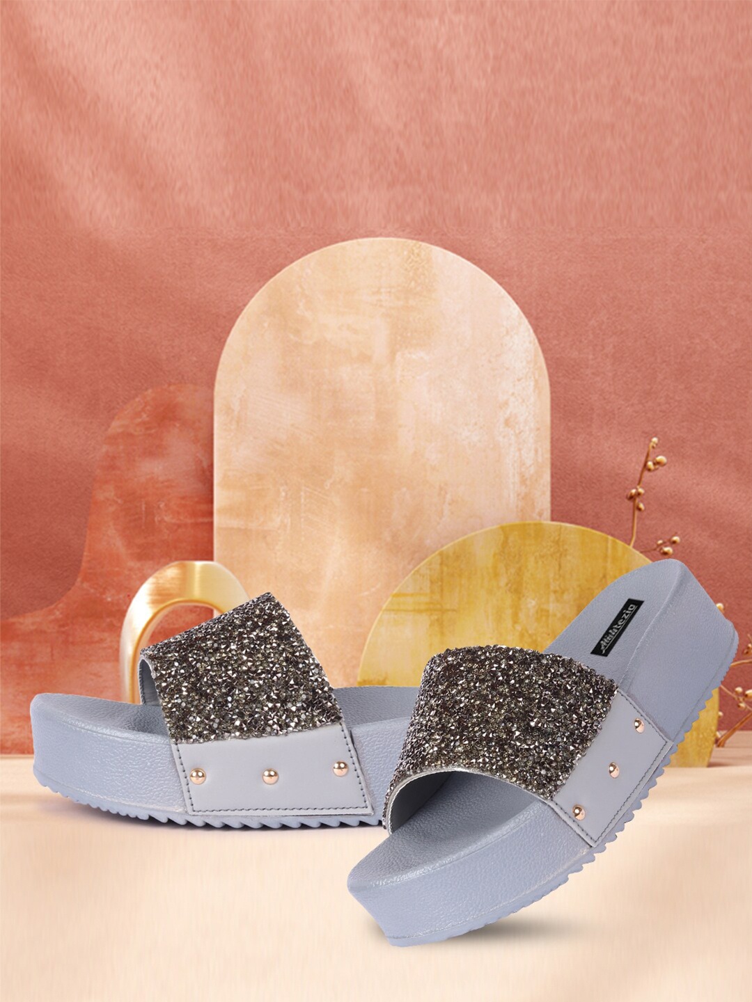 

Alishtezia Grey & Silver-Toned Embellished Flatforms