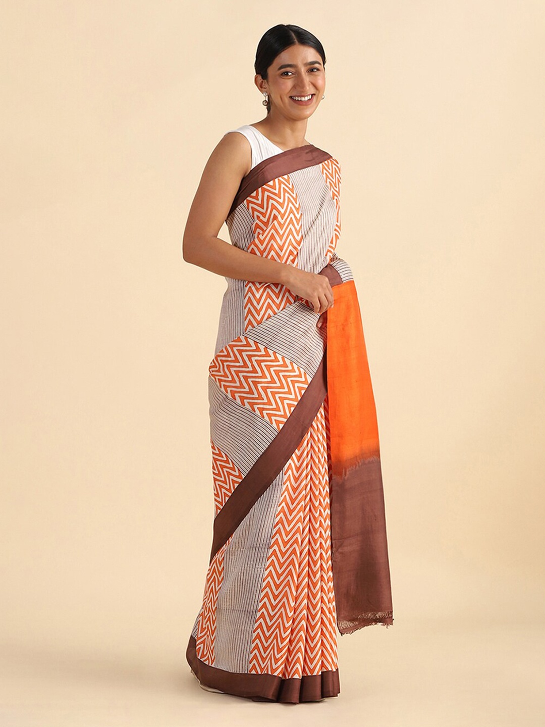 

Taneira Orange Geometric Blockprinted Pure Silk Saree