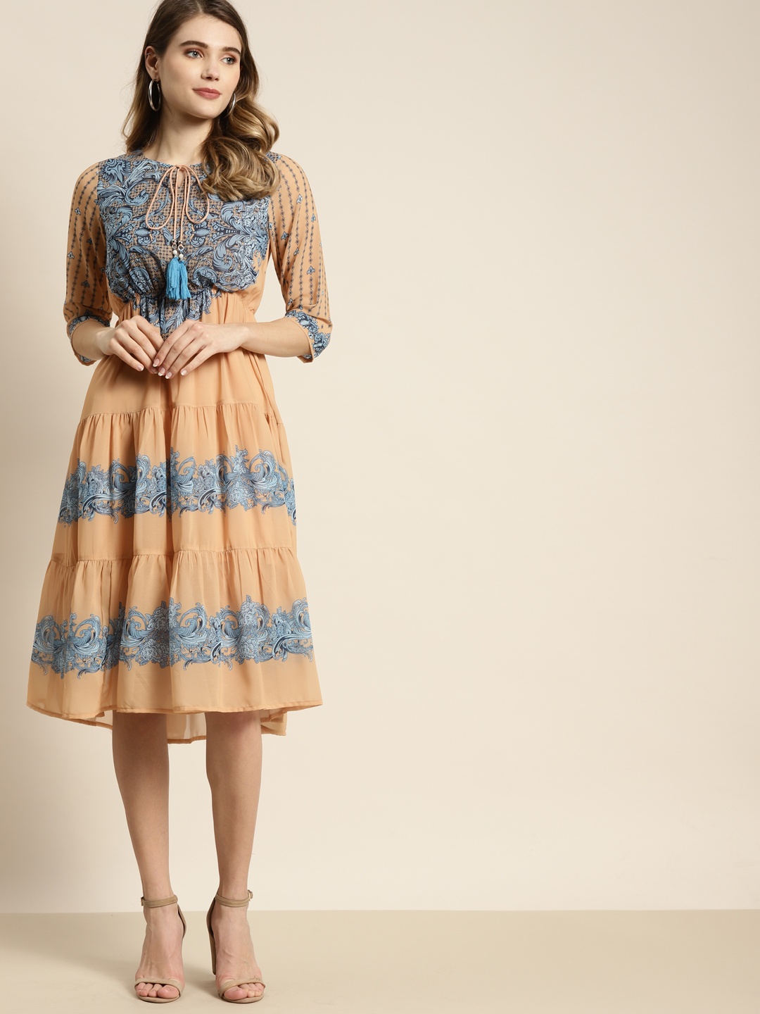 

Juniper Peach-Coloured & Teal Blue Ethnic Motifs Tie-Up Neck Tiered Fit & Flare Dress