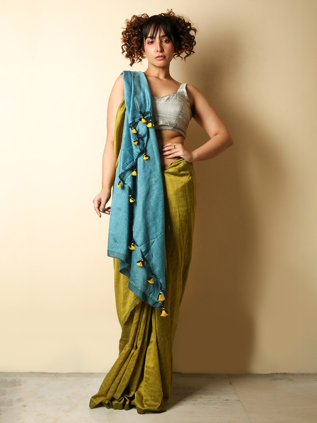 

Charukriti Olive Green & Blue Tasselled Saree