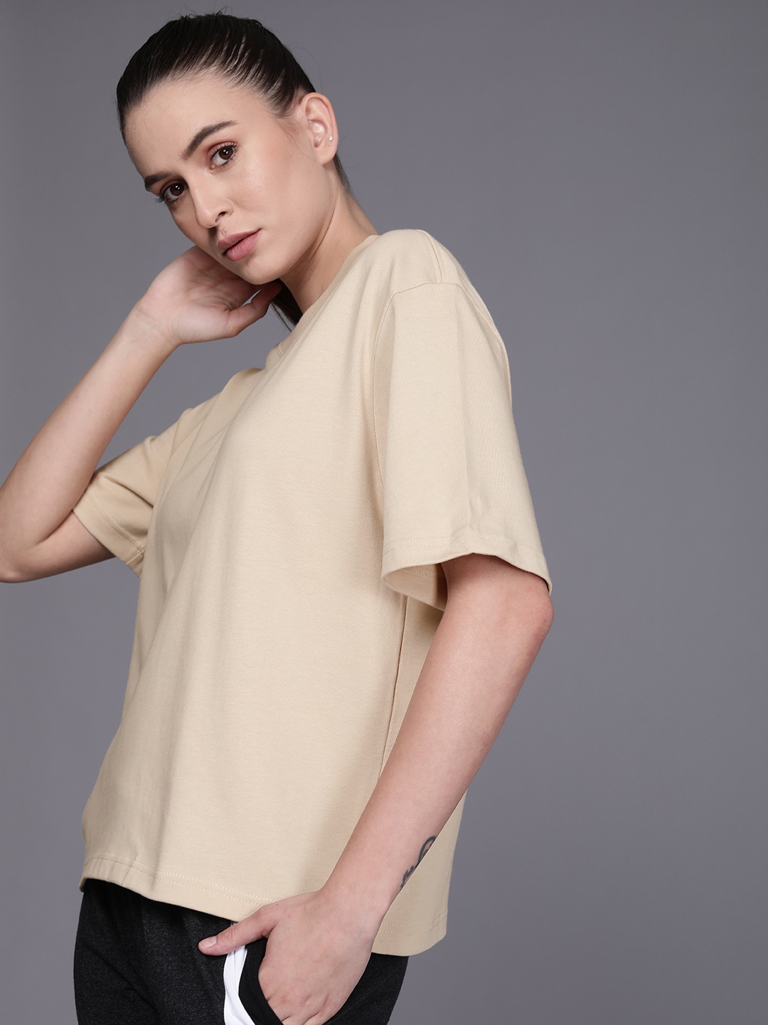 

Nike Women Beige Solid Round-Neck Pure Cotton Loose T-shirt