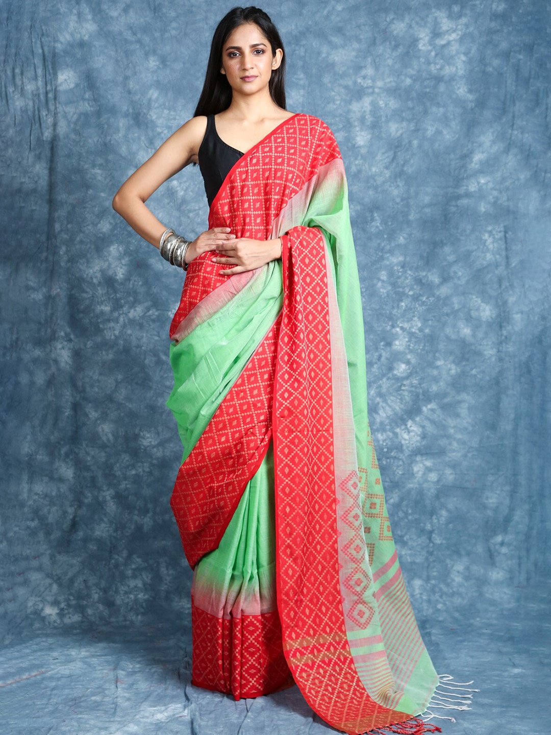 

Charukriti Green & Red Ethnic Motifs Saree