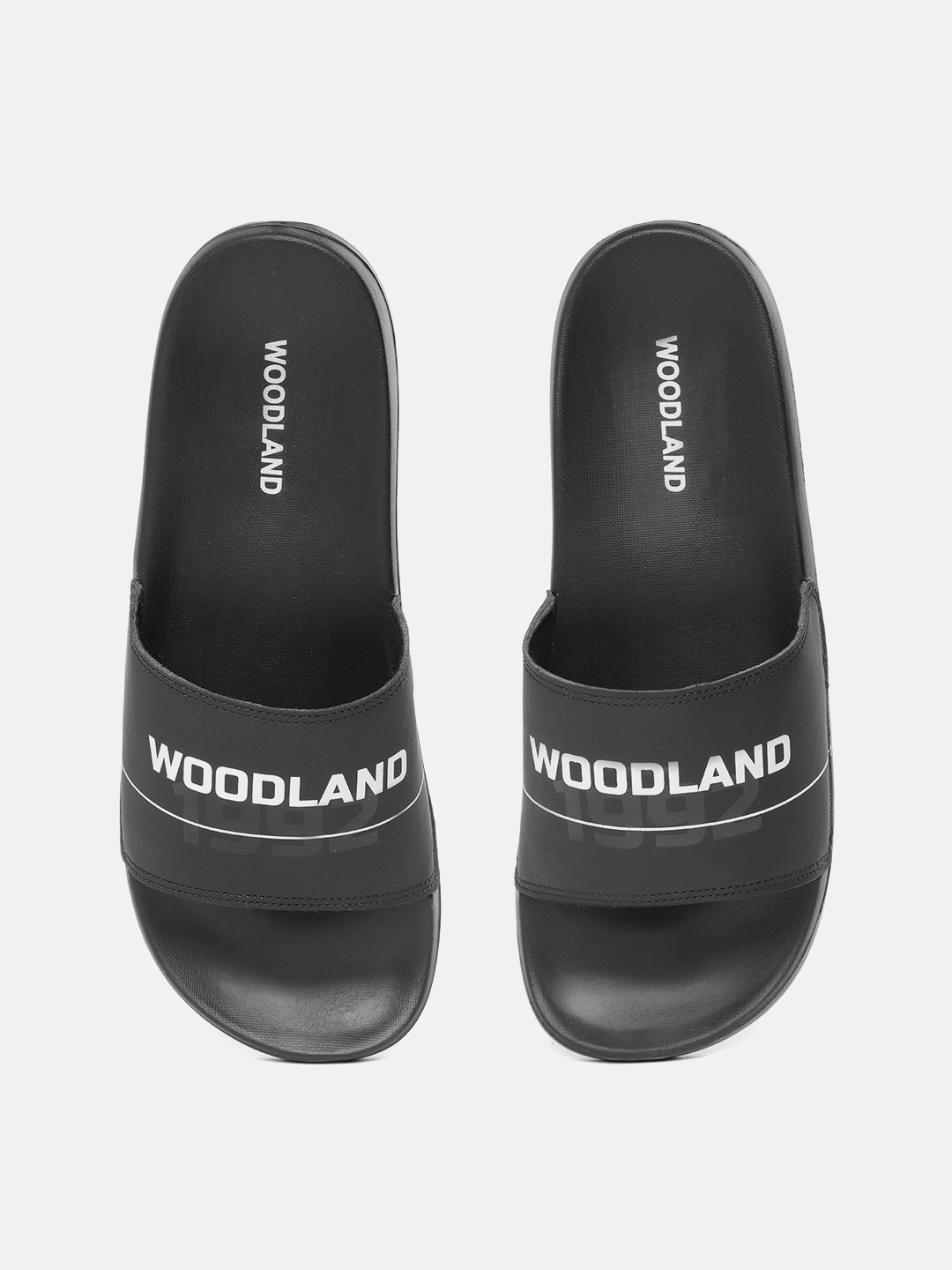 

Woodland Men Black & White Brand Logo Printed Shock-Resistance Sliders