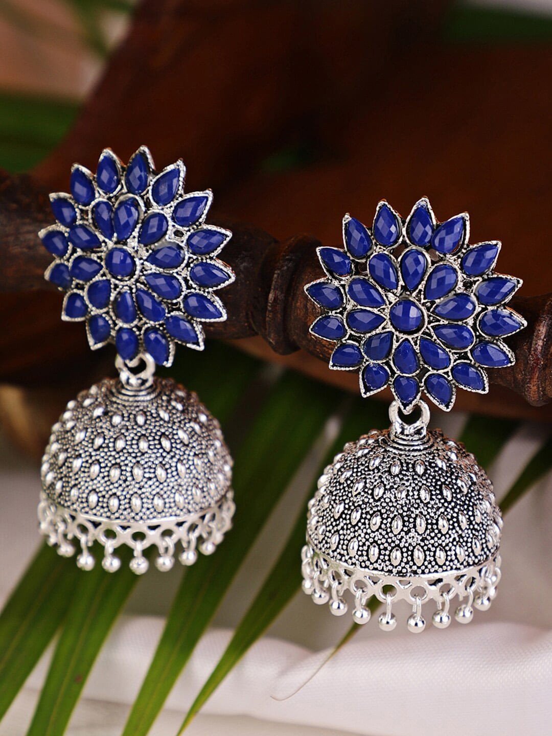 

Shining Diva Women Silver-Toned & Blue Stoned Studded Contemporary Jhumkas