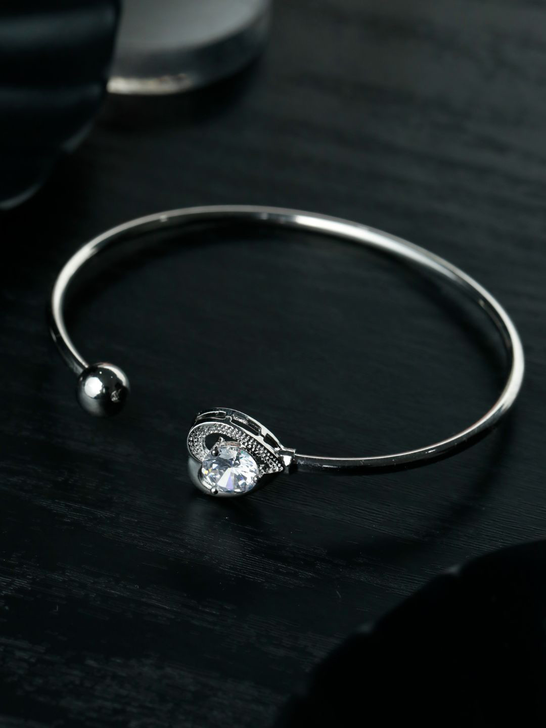 

Priyaasi Women Silver-Plated & White American Diamond Brass Cuff Bracelet